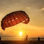 silhouette-man-is-preparing-para-sailing-sunset-beach-thailand_30478-638
