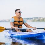 young-man-kayaking-river_1303-16029